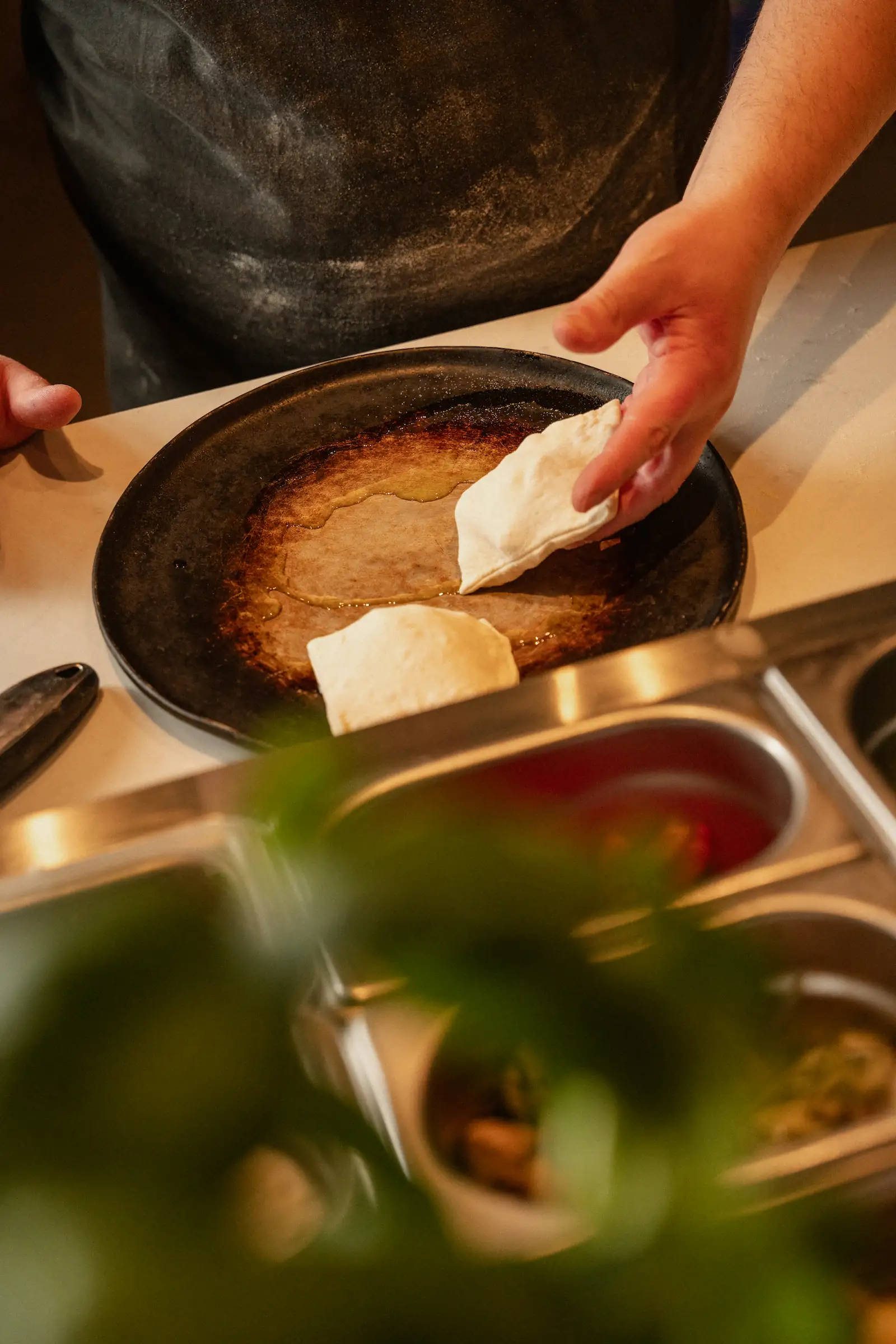 A chef is preparing a dish with savoury parcels.